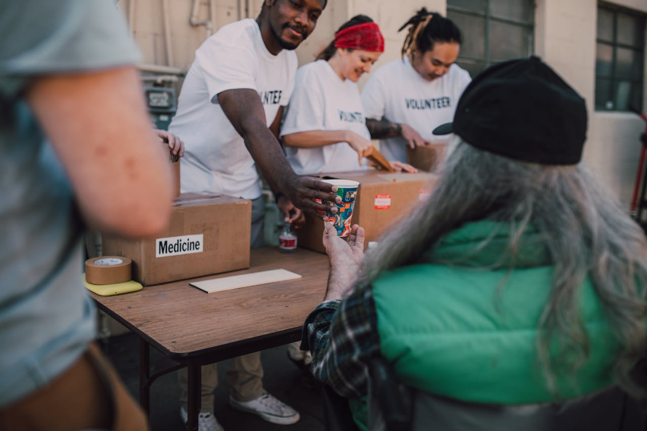 About Volunteers handing out donations and support to those in need at a community event.